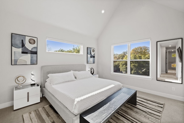 bedroom featuring carpet flooring and high vaulted ceiling