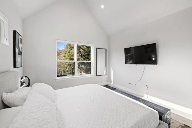 bedroom featuring carpet floors and high vaulted ceiling