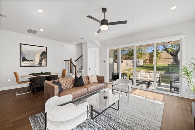 living room featuring dark hardwood / wood-style flooring and ceiling fan