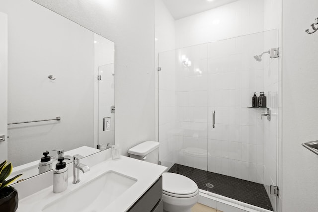 bathroom with vanity, toilet, and walk in shower