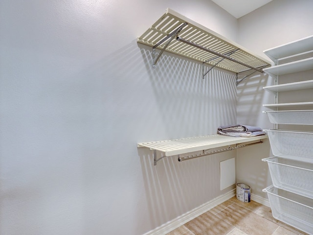 walk in closet featuring light tile patterned flooring