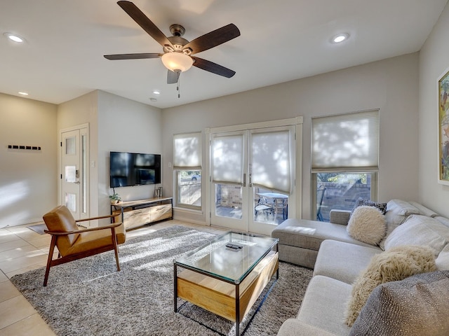 living room featuring ceiling fan, light tile patterned floors, and french doors