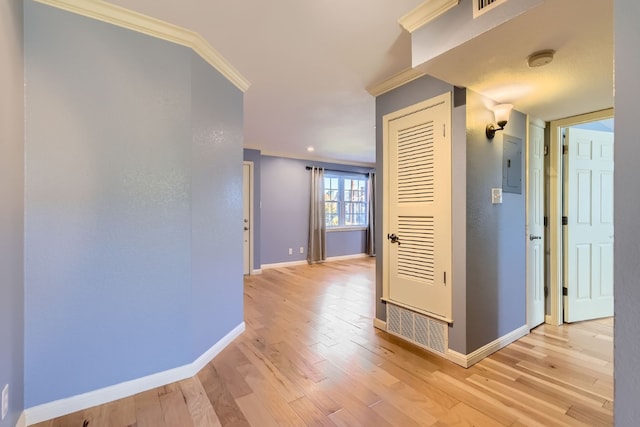 corridor featuring electric panel, light hardwood / wood-style flooring, and ornamental molding