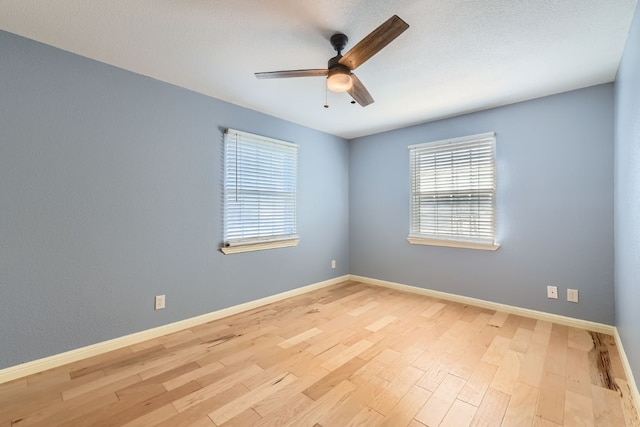 unfurnished room featuring ceiling fan and light hardwood / wood-style flooring