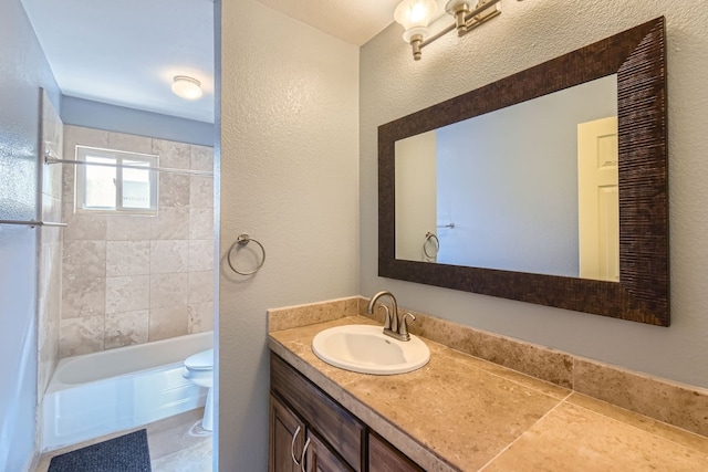 full bathroom with vanity, toilet, and tiled shower / bath combo