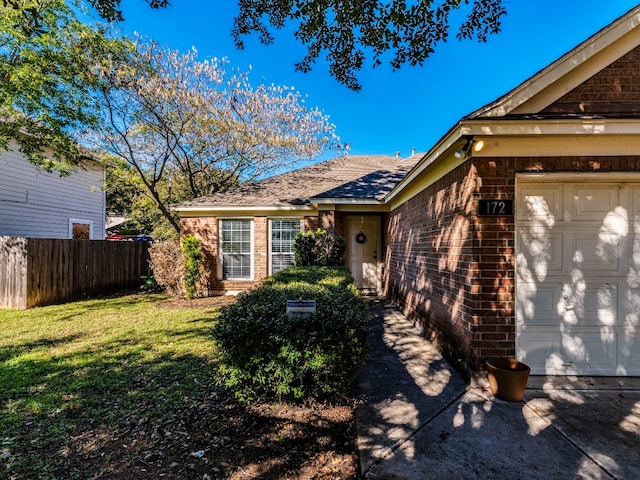 view of front of property featuring a front yard and a garage