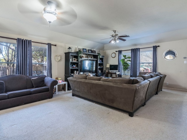 carpeted living room featuring ceiling fan and a healthy amount of sunlight