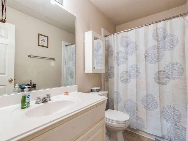 bathroom featuring tile patterned flooring, vanity, and toilet