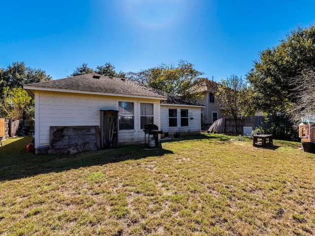 back of house with a lawn