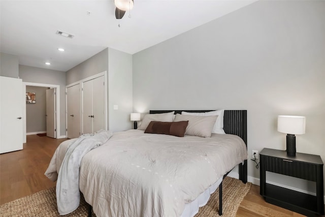 bedroom featuring ceiling fan, light hardwood / wood-style floors, and a closet