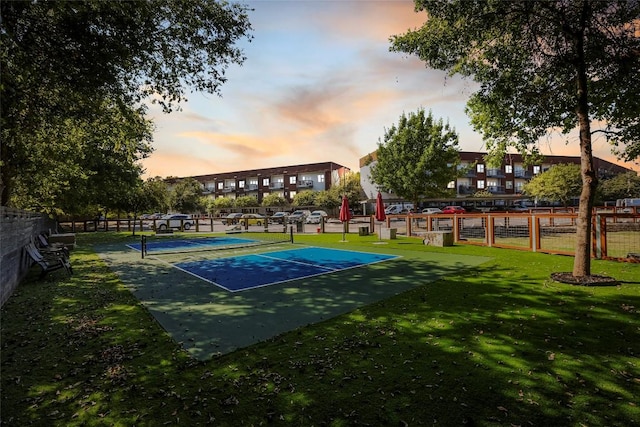 view of sport court featuring a lawn and tennis court