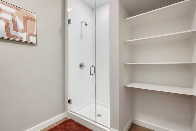 bathroom featuring a shower with shower door