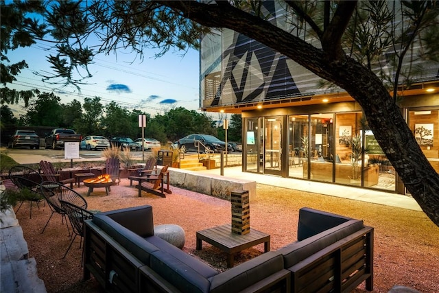 view of patio with a fire pit and a sunroom