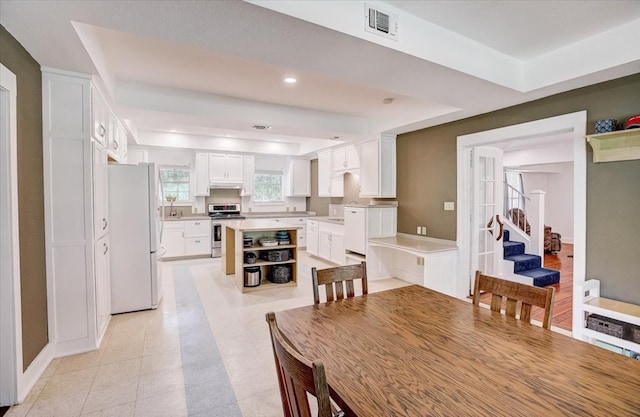 dining area featuring a raised ceiling