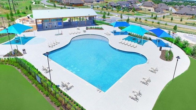 view of swimming pool with a water view and a patio