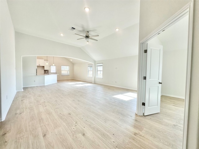 unfurnished living room with ceiling fan, lofted ceiling, and light hardwood / wood-style flooring