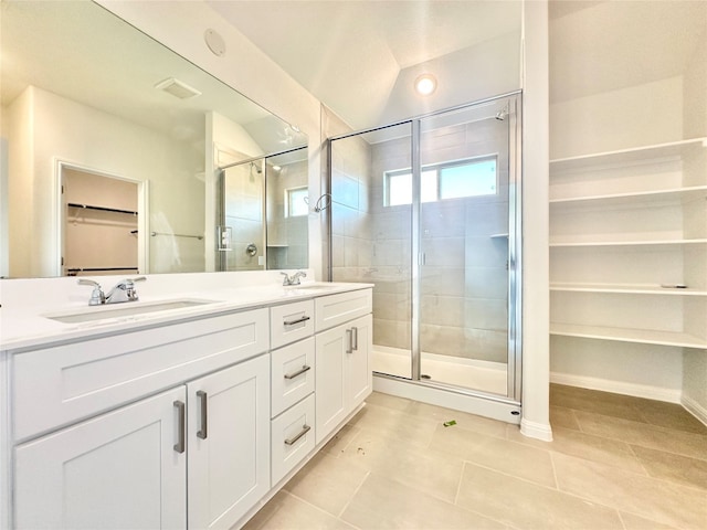 bathroom featuring tile patterned floors, lofted ceiling, vanity, and an enclosed shower