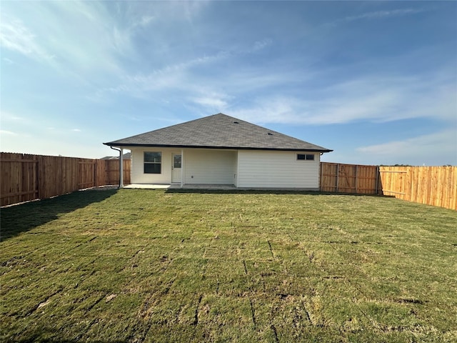 rear view of house with a yard