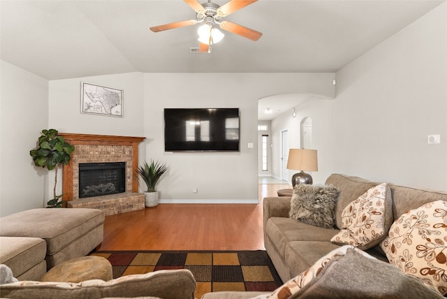 living room with ceiling fan, hardwood / wood-style floors, and lofted ceiling