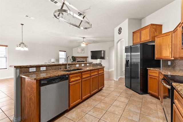 kitchen with ceiling fan with notable chandelier, stainless steel appliances, a wealth of natural light, and sink