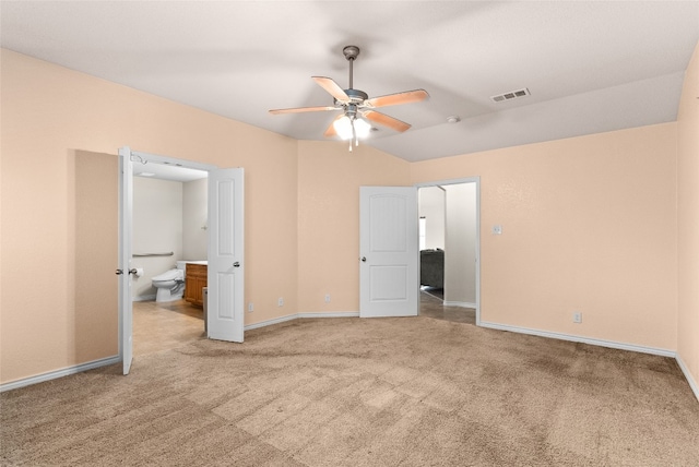 unfurnished bedroom with ceiling fan, carpet, and ensuite bathroom