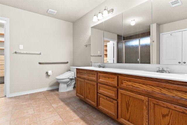 bathroom with an enclosed shower, vanity, toilet, and tile patterned flooring