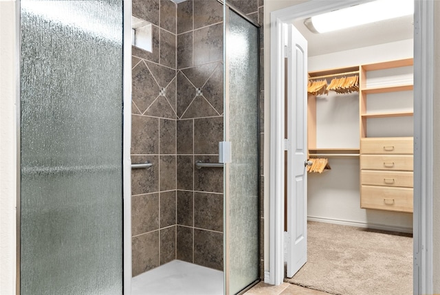 bathroom with a shower with door