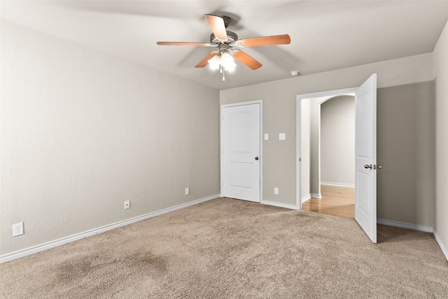 unfurnished bedroom featuring ceiling fan and light colored carpet