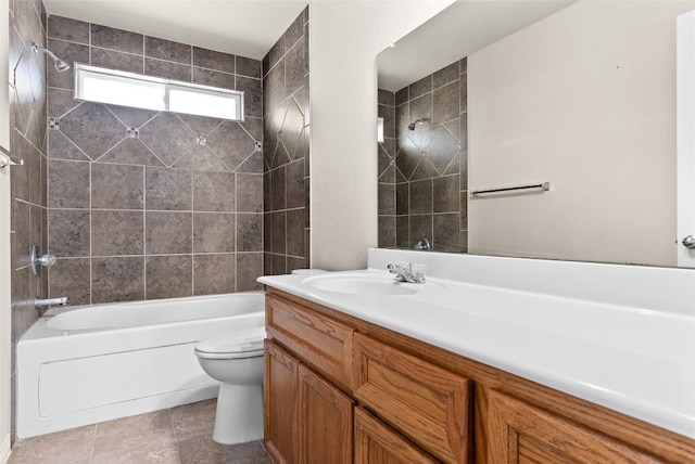 full bathroom featuring vanity, tile patterned floors, tiled shower / bath combo, and toilet