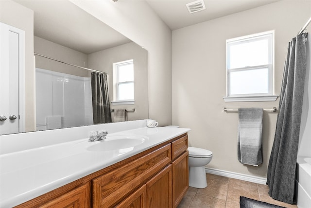 bathroom featuring tile patterned flooring, vanity, and toilet