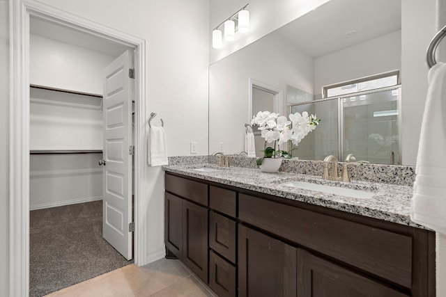 bathroom featuring vanity, tile patterned floors, and a shower with door