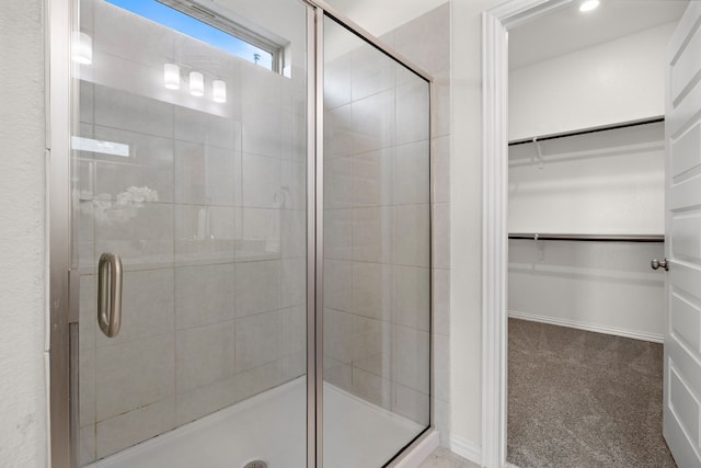 bathroom featuring a shower with shower door