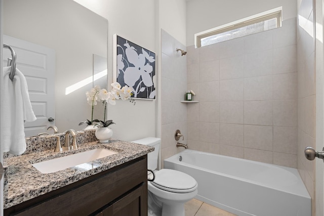 full bathroom featuring tile patterned flooring, vanity, tiled shower / bath combo, and toilet