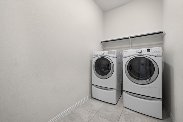 laundry room featuring light tile patterned floors and washer and dryer