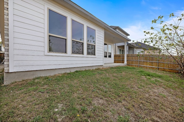 rear view of property featuring a lawn