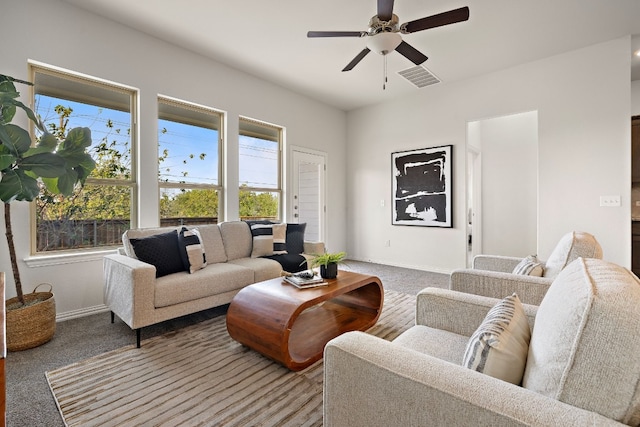 carpeted living room with a wealth of natural light and ceiling fan