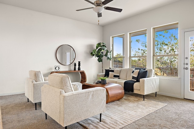 carpeted living room with ceiling fan