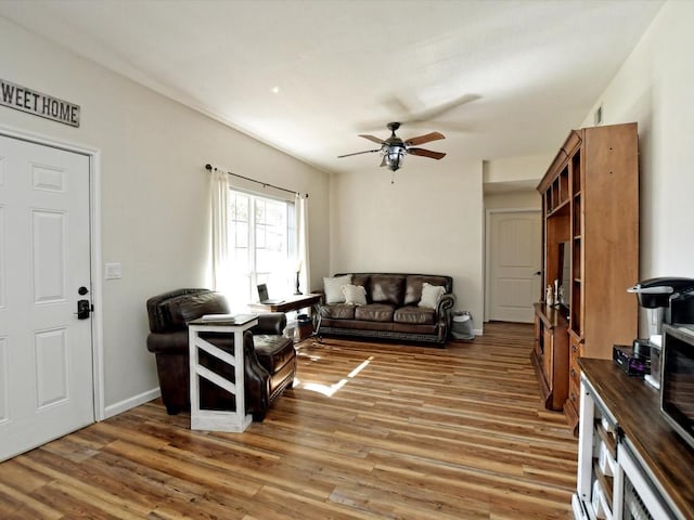 living room with dark hardwood / wood-style floors and ceiling fan