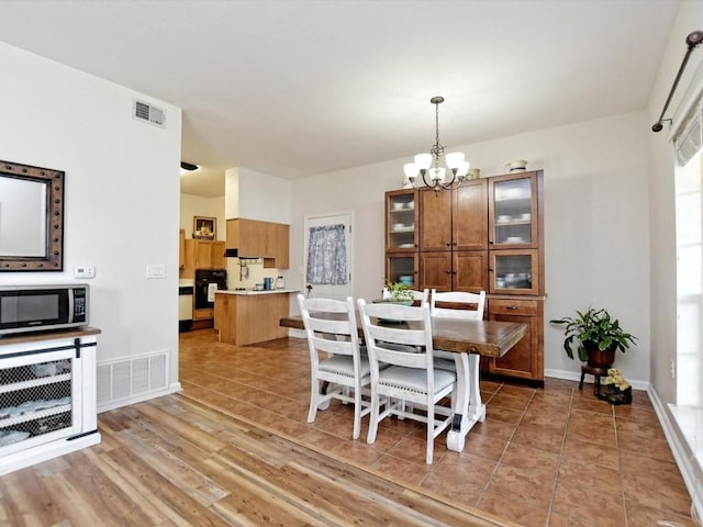 dining room featuring hardwood / wood-style floors and a notable chandelier