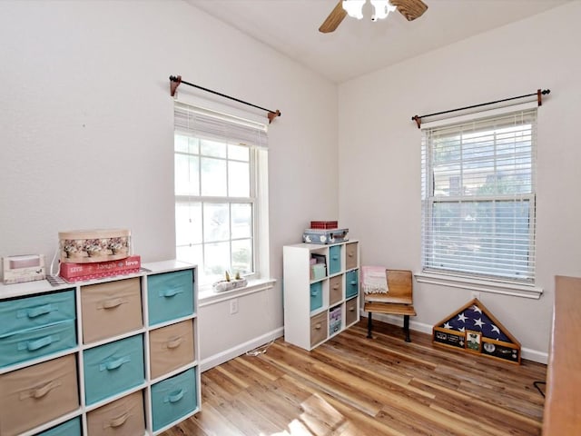 playroom featuring hardwood / wood-style flooring and ceiling fan