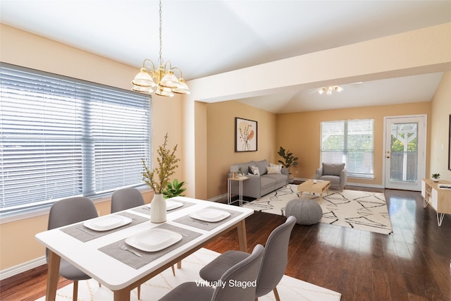 dining room featuring dark wood-type flooring and a chandelier