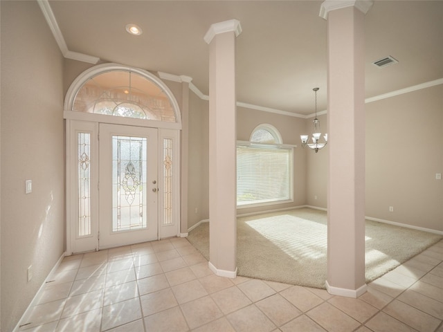 entryway featuring a notable chandelier, light tile patterned floors, and ornamental molding