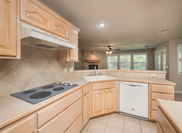 kitchen featuring black electric stovetop, light brown cabinets, white dishwasher, and sink