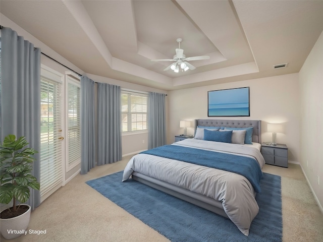 bedroom with access to exterior, ceiling fan, light carpet, and multiple windows