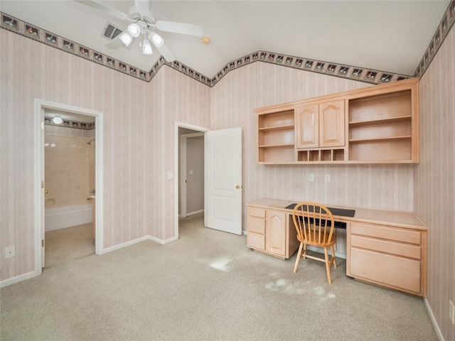 office space with light carpet, built in desk, vaulted ceiling, and ceiling fan