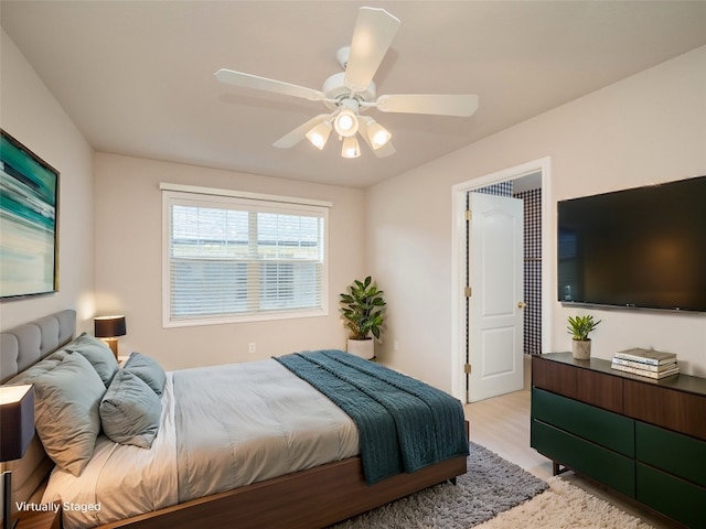 bedroom with ceiling fan and light hardwood / wood-style floors