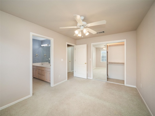 unfurnished bedroom featuring ceiling fan, a closet, and light colored carpet