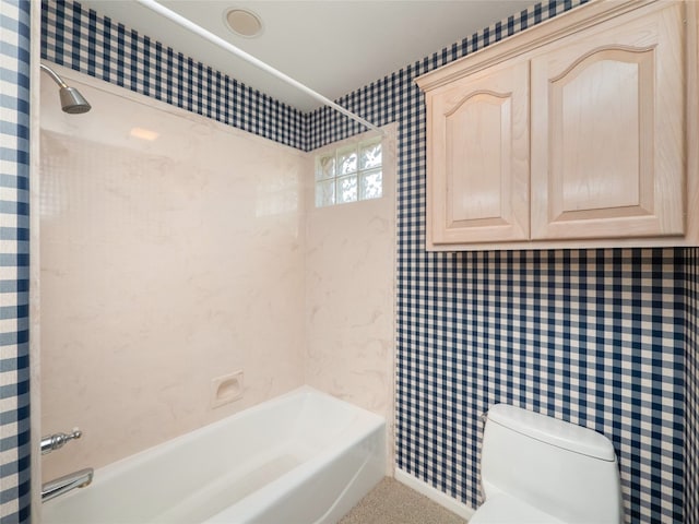 bathroom with tiled shower / bath combo and toilet