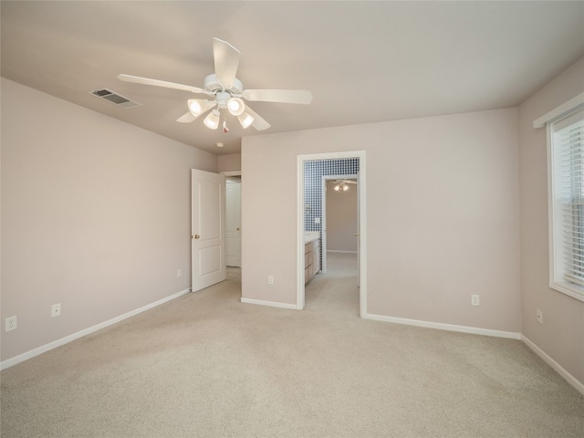 unfurnished bedroom with ceiling fan and light carpet