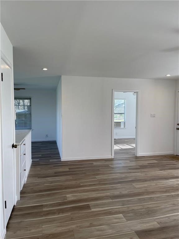 spare room featuring cooling unit and dark hardwood / wood-style floors